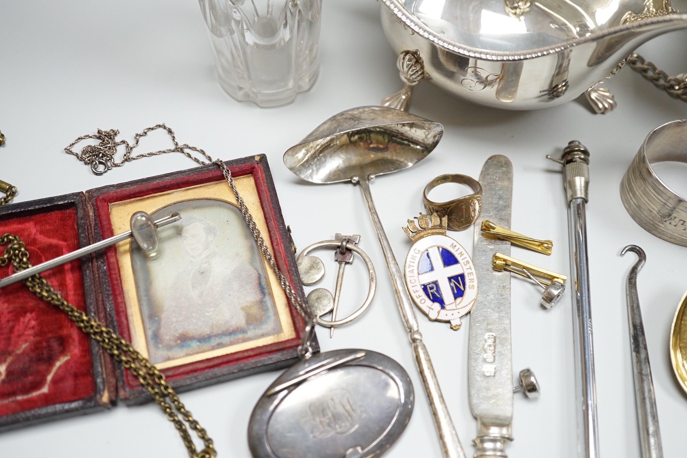 Sundry small silver including two sauceboats, napkin rings, mounted glass condiment bottle, pepperette, pair of silver gilt preserve spoons, minor flatware including white metal, a 1920's Georg Jensen silver cream ladle,